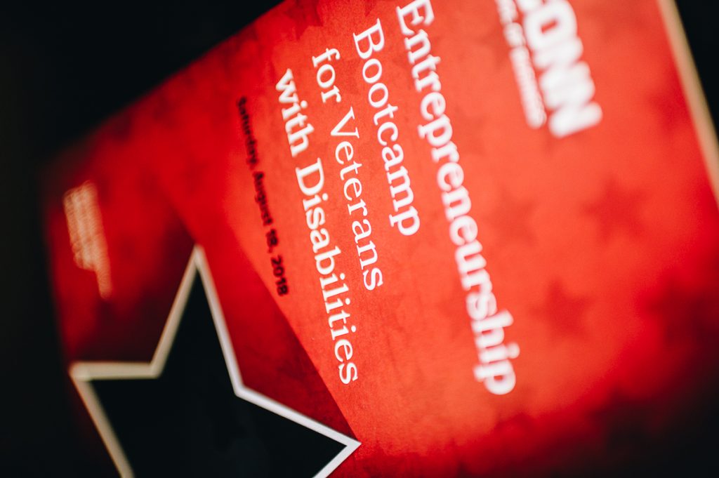 Staged photo of a UConn School of Business flyer with the text "Entrepreneurship Bootcamp for Veterans with Disabilities."